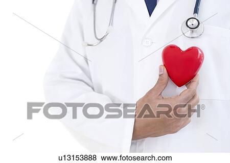 Doctor holding heart shape. View Large Photo Image Stock Photo - Doctor holding heart shape.. Fotosearch