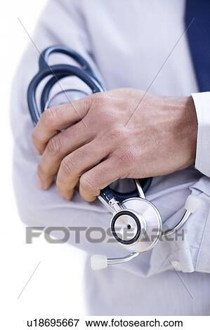 Doctor holding stethoscope, close-up. View Large Photo Image Stock Photo - Doctor holding stethoscope, close-up.. Fotosearch