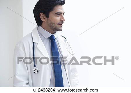 Picture - Doctor with stethoscope, looking away.. Fotosearch