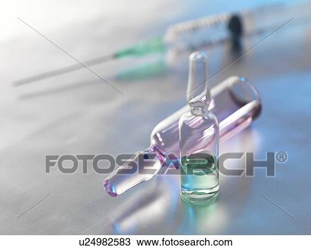 Stock Image - Drug ampules and syringe awaiting injection.. Fotosearch