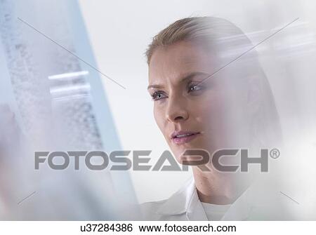 Genetics research. Scientist viewing DNA (deoxyribonucleic acid) results on a autoradiogram. View Large Photo Image Stock Photograph - Genetics research. Scientist viewing DNA (deoxyribonucleic acid) results on a autoradiogram.. Fotosearch