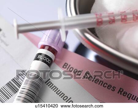 Stock Image - Human blood sample alongside blood test request form.. Fotosearch
