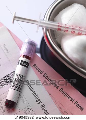Stock Image - Human blood sample alongside blood test request form.. Fotosearch