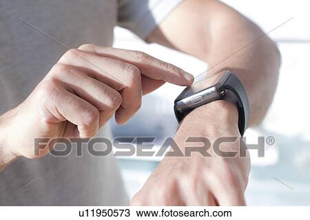 Man checking his smart watch. View Large Photo Image Stock Image - Man checking his smart watch.. Fotosearch