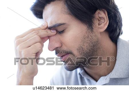 Man pinching the bridge of his nose. View Large Photo Image Stock Image - Man pinching the bridge of his nose.. Fotosearch
