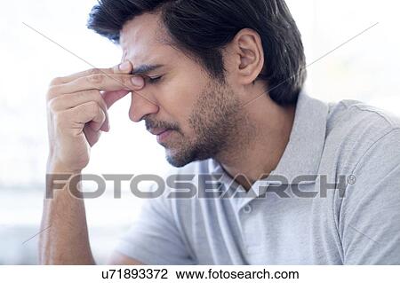 Man pinching the bridge of his nose. View Large Photo Image Stock Image - Man pinching the bridge of his nose.. Fotosearch