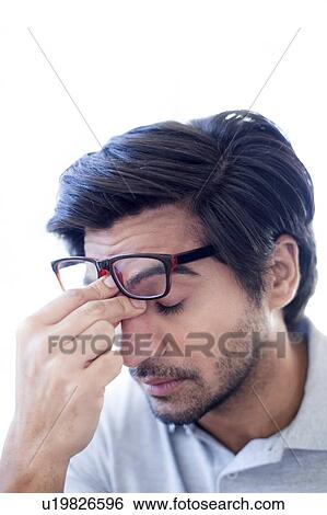 Man pinching the bridge of his nose, wearing glasses. View Large Photo Image Stock Photograph - Man pinching the bridge of his nose, wearing glasses.. Fotosearch