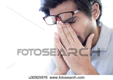 Man pinching the bridge of his nose, wearing glasses. View Large Photo Image Stock Photograph - Man pinching the bridge of his nose, wearing glasses.. Fotosearch