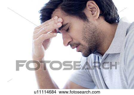 Man touching his forehead. View Large Photo Image Picture - Man touching his forehead.. Fotosearch