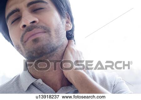 Man touching his neck in pain. View Large Photo Image Stock Photo - Man touching his neck in pain.. Fotosearch
