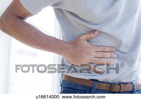 Man touching his stomach in pain. View Large Photo Image Stock Image - Man touching his stomach in pain.. Fotosearch