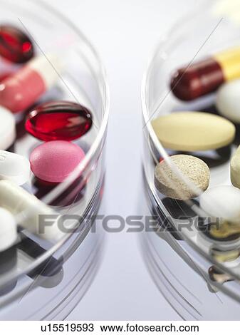Stock Image - Pharmaceutical research, conceptual image. A variety of medicines sitting in a petri dish.. Fotosearch
