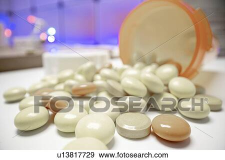 Stock Photo - Pills spilling from bottle.. Fotosearch