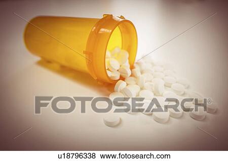 Pills spilling from bottle. View Large Photo Image Stock Photo - Pills spilling from bottle.. Fotosearch