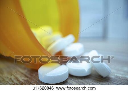Stock Photograph - Pills spilling from bottle.. Fotosearch