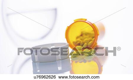Stock Photograph - Pills spilling from bottle.. Fotosearch
