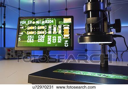 Stock Image - Quality control in microchip factory.. Fotosearch