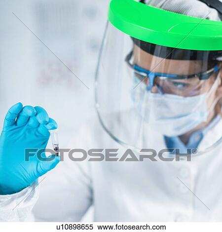 Stock Photography - Ancient DNA scientist working in bio archaeology lab. Fotosearch