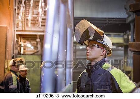 Stock Image - Apprentice worker in steelworks. Fotosearch