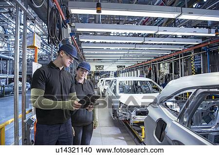 Apprentices inspecting cars on production line in car factory View Large Photo Image Stock Image - Apprentices inspecting cars on production line in car factory. Fotosearch
