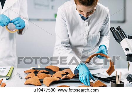 Archaeologists reconstructing broken pottery View Large Photo Image Stock Image - Archaeologists reconstructing broken pottery. Fotosearch
