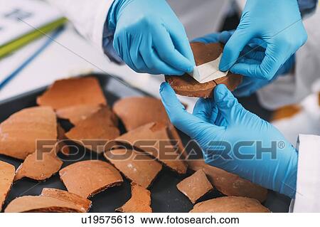 Archaeologists reconstructing broken pottery View Large Photo Image Stock Image - Archaeologists reconstructing broken pottery. Fotosearch