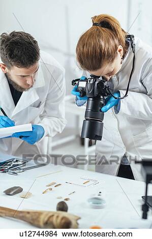 Archaeology researchers documenting artefacts View Large Photo Image Picture - Archaeology researchers documenting artefacts. Fotosearch