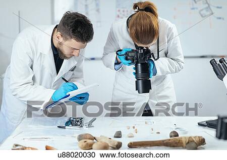 Archaeology researchers documenting artefacts View Large Photo Image Stock Image - Archaeology researchers documenting artefacts. Fotosearch