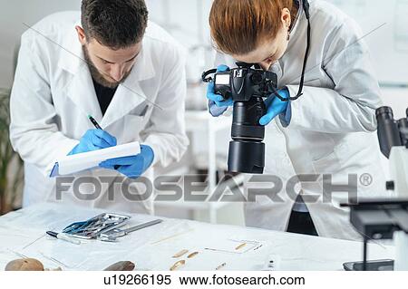 Archaeology researchers documenting artefacts View Large Photo Image Stock Photography - Archaeology researchers documenting artefacts. Fotosearch