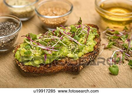 Stock Photography - Avocado and bean sprouts on toast. Fotosearch