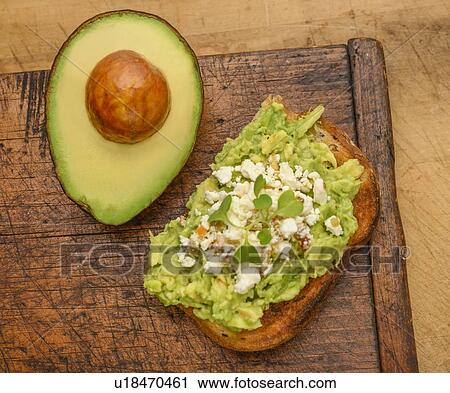Stock Image - Avocado and feta on toast. Fotosearch