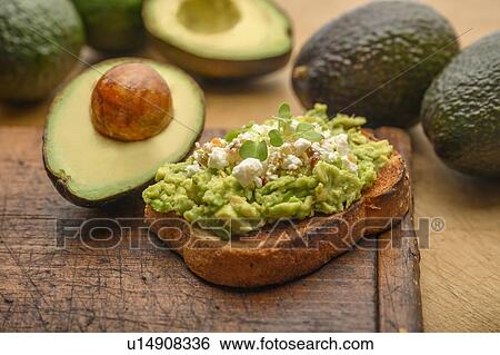 Stock Photograph - Avocado and feta on toast. Fotosearch