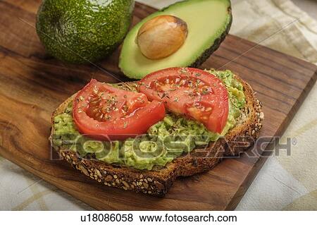 Stock Photo - Avocado and tomato on toast. Fotosearch