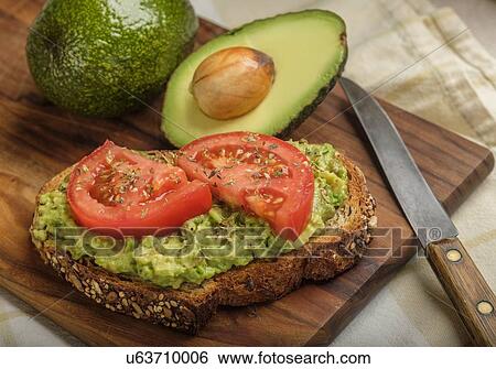 Stock Photograph - Avocado and tomato on toast. Fotosearch