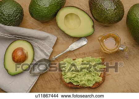 Avocado on toast with spoon and oil View Large Photo Image Picture - Avocado on toast with spoon and oil. Fotosearch