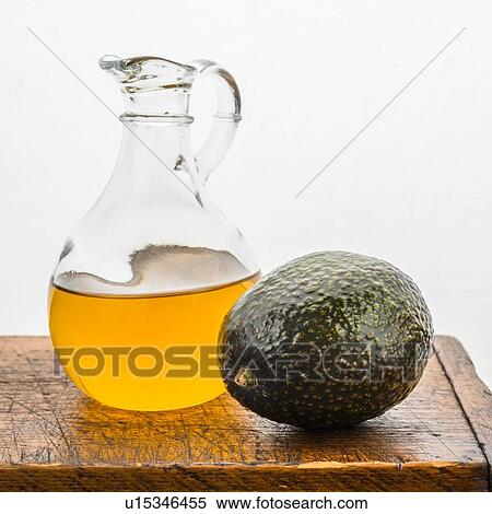 Stock Photography - Avocado with pitcher of oil. Fotosearch
