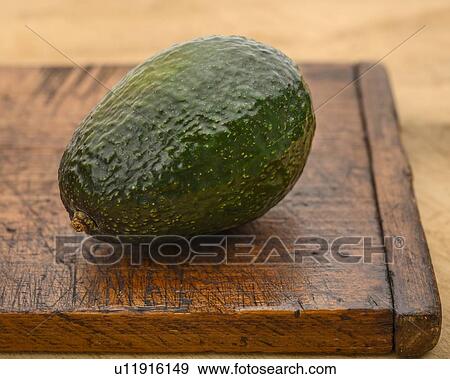 Avocados on cutting board View Large Photo Image Stock Photo - Avocados on cutting board. Fotosearch