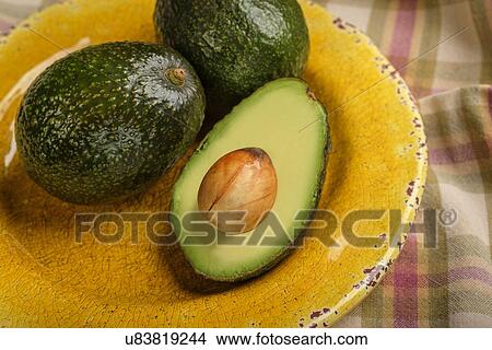 Avocados on plate View Large Photo Image Picture - Avocados on plate. Fotosearch