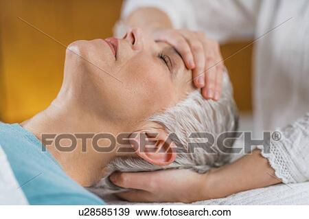 Stock Photo - Ayurveda facial marma massage. Fotosearch