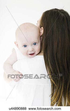 Stock Photo - Baby boy looking over his mother's shoulder. Fotosearch