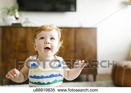 Stock Photography - Baby boy looking up. Fotosearch
