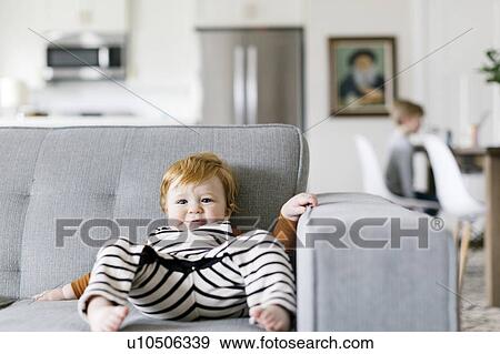 Baby boy slumped on sofa View Large Photo Image Stock Photo - Baby boy slumped on sofa. Fotosearch