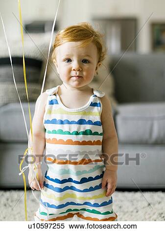 Stock Photography - Baby boy wearing striped romper. Fotosearch