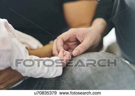 Baby holding mother's finger View Large Photo Image Stock Photo - Baby holding mother's finger. Fotosearch