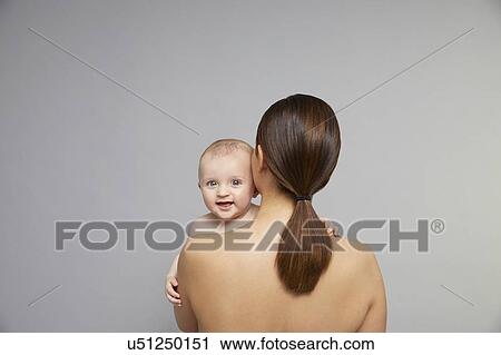 Baby looking over mother's shoulder View Large Photo Image Stock Image - Baby looking over mother's shoulder. Fotosearch