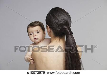 Stock Photo - Baby looking over mother's shoulder. Fotosearch