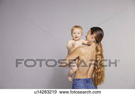 Stock Photo - Baby looking over mother's shoulder. Fotosearch