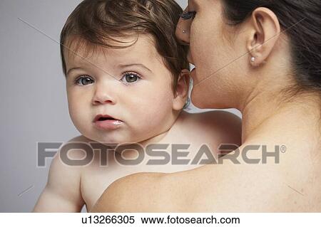 Baby looking over mother's shoulder View Large Photo Image Stock Photography - Baby looking over mother's shoulder. Fotosearch