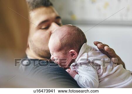 Baby resting on father's chest at home View Large Photo Image Stock Image - Baby resting on father's chest at home. Fotosearch
