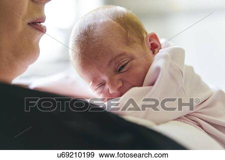 Stock Photo - Baby resting on mother's chest. Fotosearch
